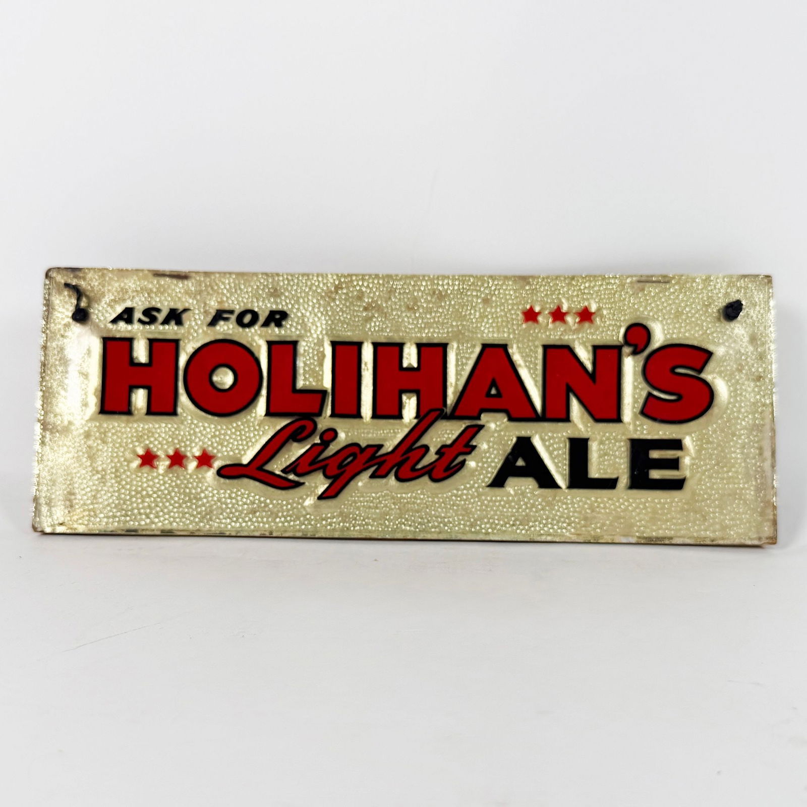 Holihans Light Ale Celluloid Over Textured Cardboard Sign RARE: Diamond Spring Brewery. Lawrence, Massachusetts. Circa 1940s. Rare sign. Reverse painted celluloid over embossed, textured gold metallic foil-topped cardboard. 11 x 4 inches. 