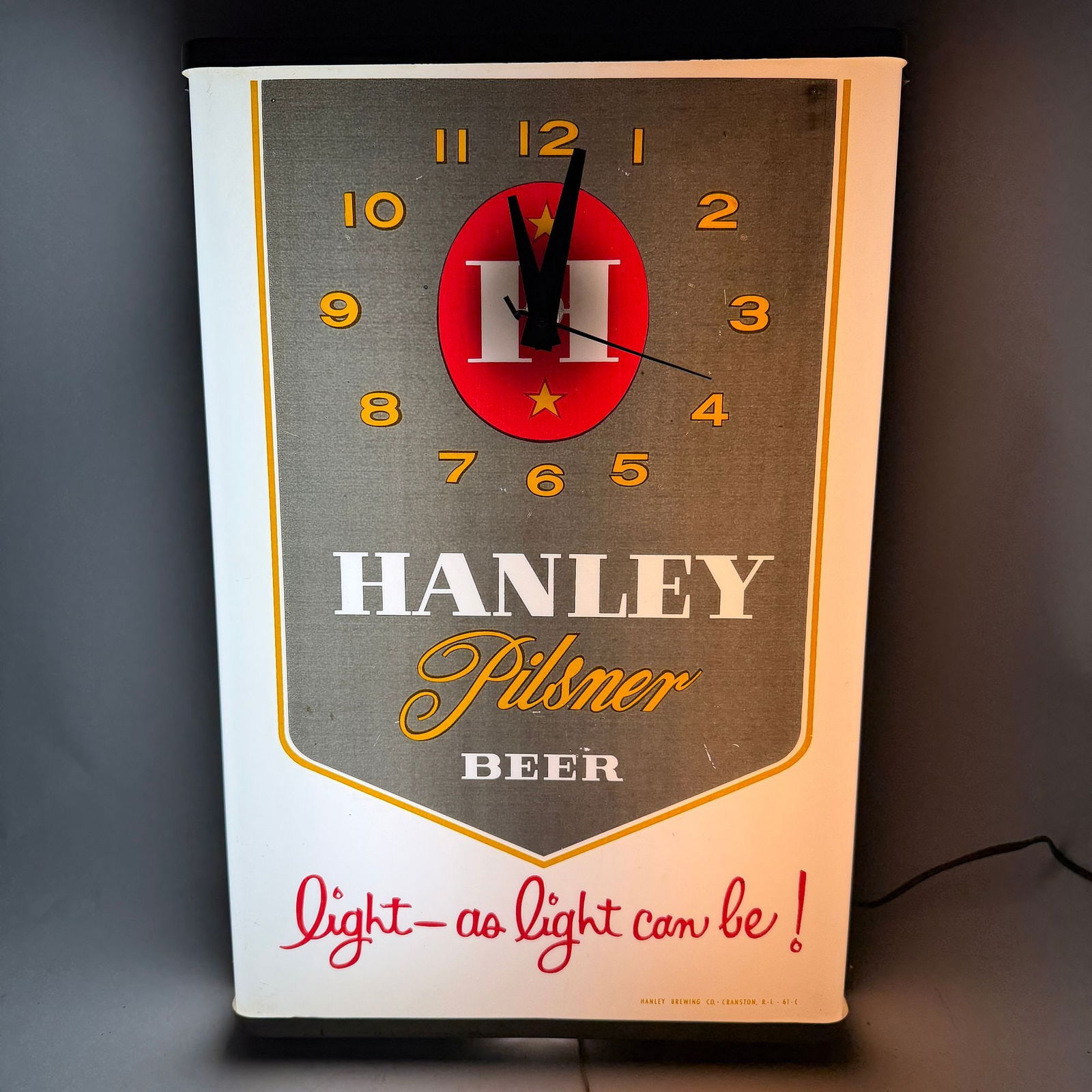 Hanley Pilsner Beer Light As Light Can Be illuminated Clock Sign EXCEPTIONAL: James Hanley. Providence, Rhode Island. Circa 1960s. Near perfect. Just some slight wear at metal edges. Currently in good working condition. About 13 x 18 x 4 inches.