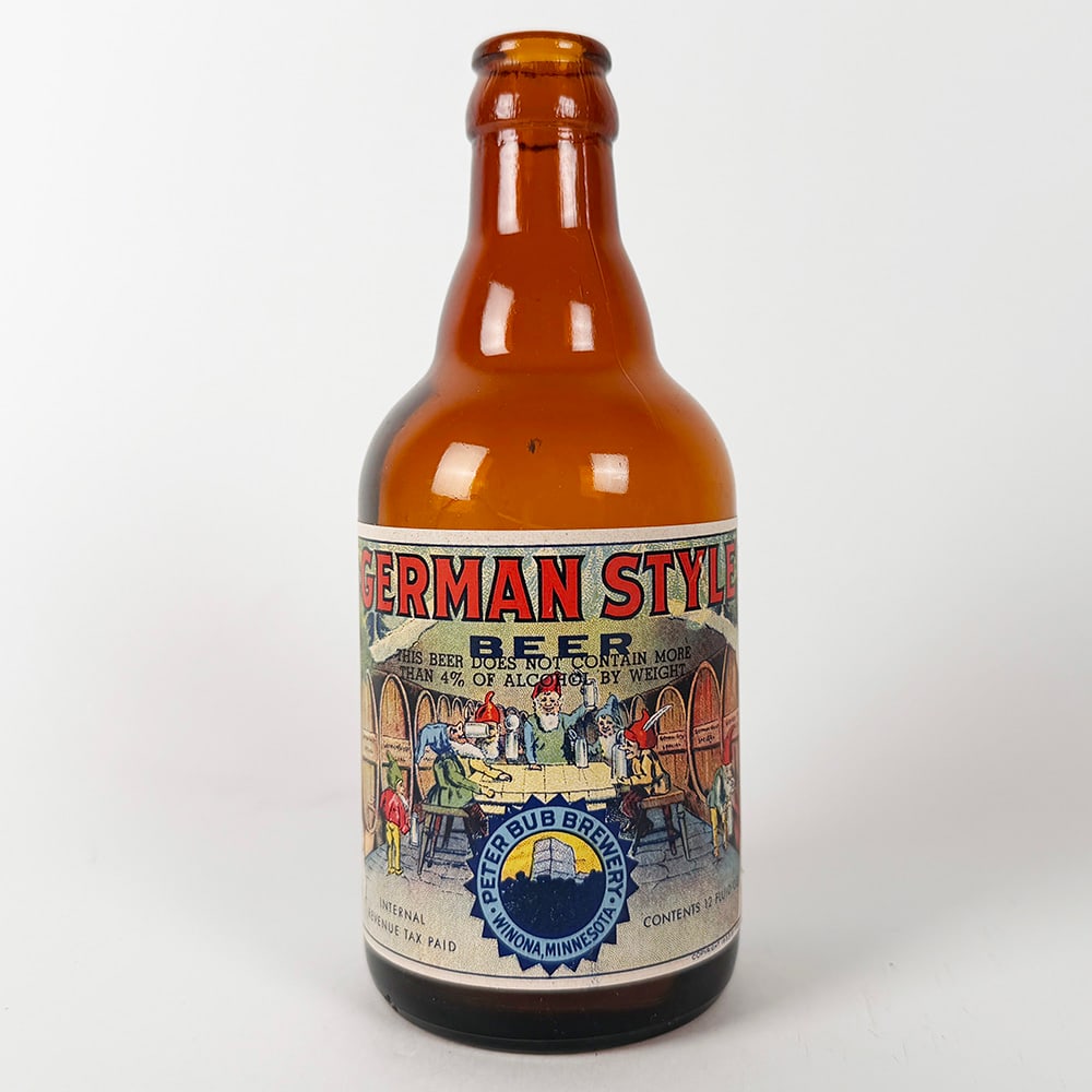 Peter Bub Brewery German Style Beer Steinie Bottle WINONA MN: Circa 1940s Peter Bub Brewery German Style Beer bottle from Winona, Minnesota. The label features a colorful illustration of people drinking around a table with barrels in the background. The label al