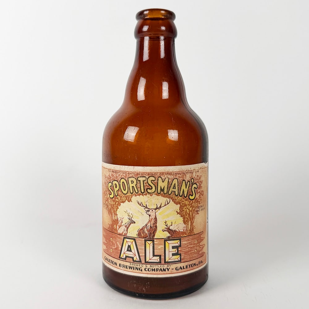 Sportsman's Ale Steinie Bottle Galeton Brewing PA: Circa 1940s Sportsman's Ale bottle from the Galeton Brewing Company, Galeton, Pennsylvania. Features a brown glass bottle with a label depicting deer in a forest scene. 
