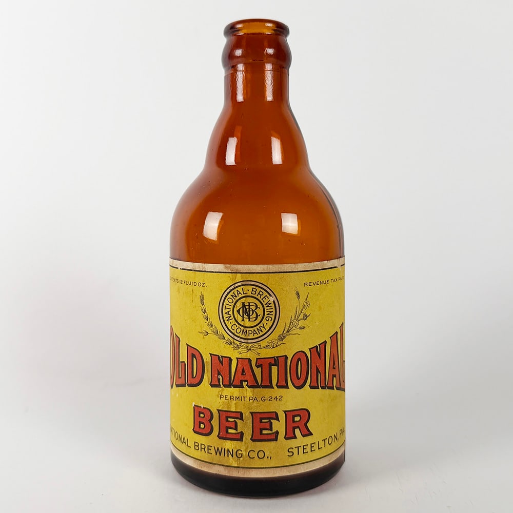 Old National Beer Steinie Bottle Steelton PA: Circa 1930s steinie bottle from National Brewing Co., Steelton, Pennsylvania. Features a yellow label with red lettering. Marked 'Permit PA-G-242'. 