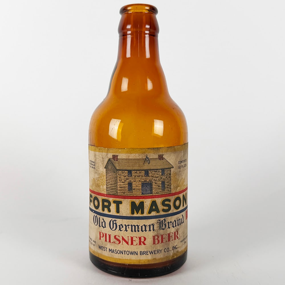Fort Mason Old German Brand Pilsner Steinie Beer Bottle Norristown PA: Circa 1940s steinie beer bottle featuring the Fort Mason Old German Brand Pilsner Beer label. Brewed and bottled by West Masontown Brewery Co., Inc., Northampton, Pennsylvania. 12 fl. oz.