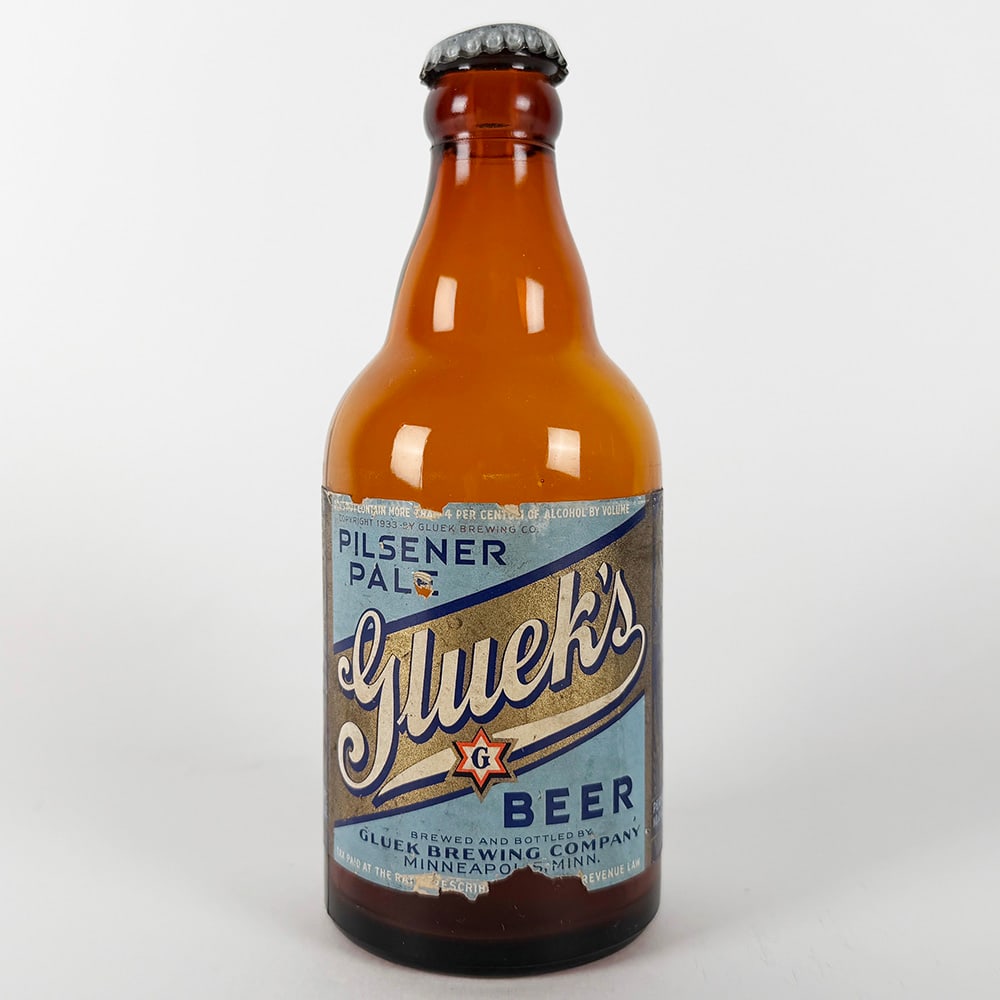 Gluek Brewing Pilsener Pale Beer Steinie Bottle Minneapolis MN: Circa 1930s Gluek Brewing Company Pilsener Pale beer steinie bottle. Brewed and bottled by Gluek Brewing Co., Minneapolis, Minnesota. Tax paid at the rate prescribed by revenue law. 12 fl. oz.