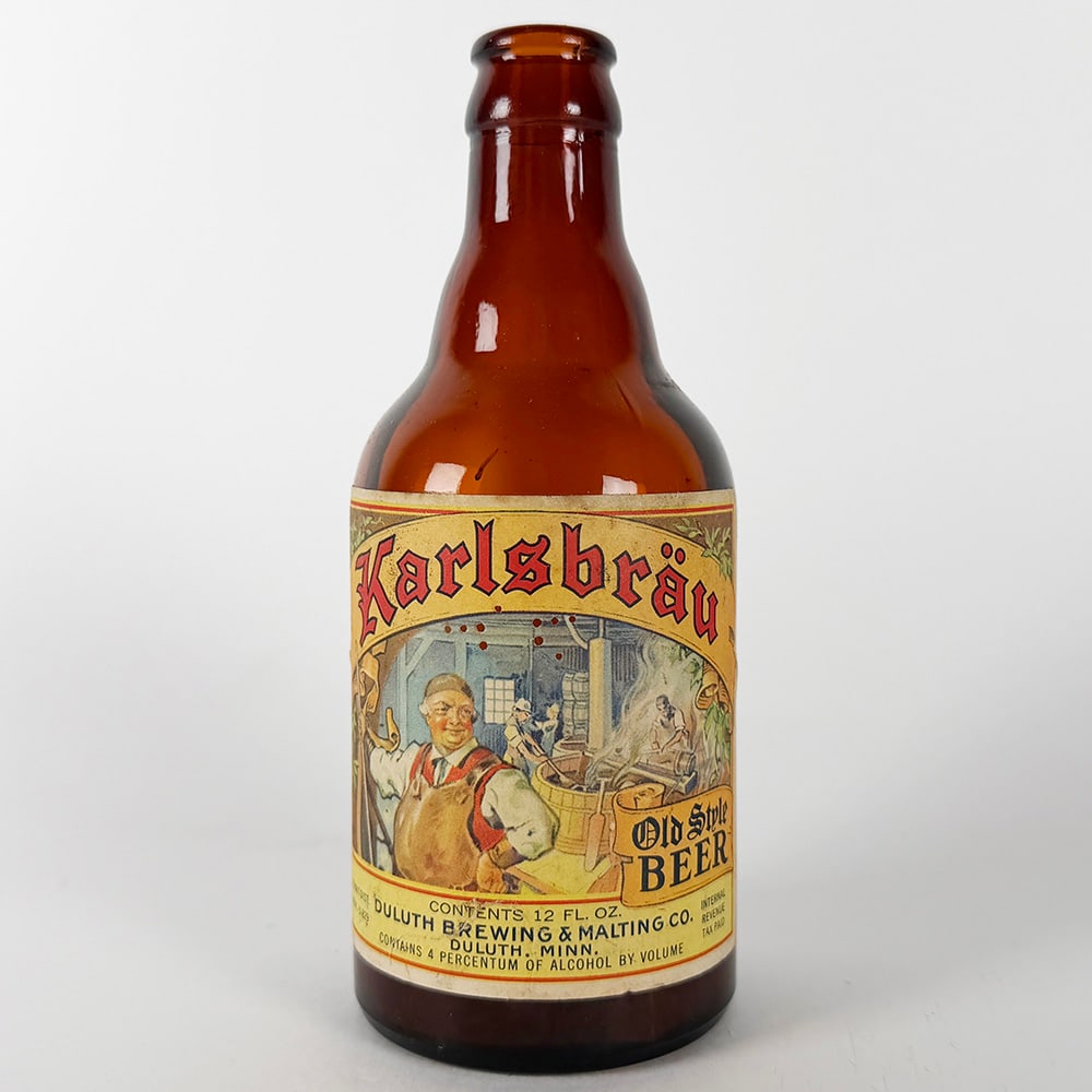Karlsbrau Old Style Beer Steinie Bottle - Duluth Brewing & Malting MN: Circa 1930s Karlsbrau Old Style Beer steinie bottle from Duluth Brewing & Malting Co. of Duluth, Minnesota. Features a colorful label depicting a brewing scene. 12 fl. oz. bottle.