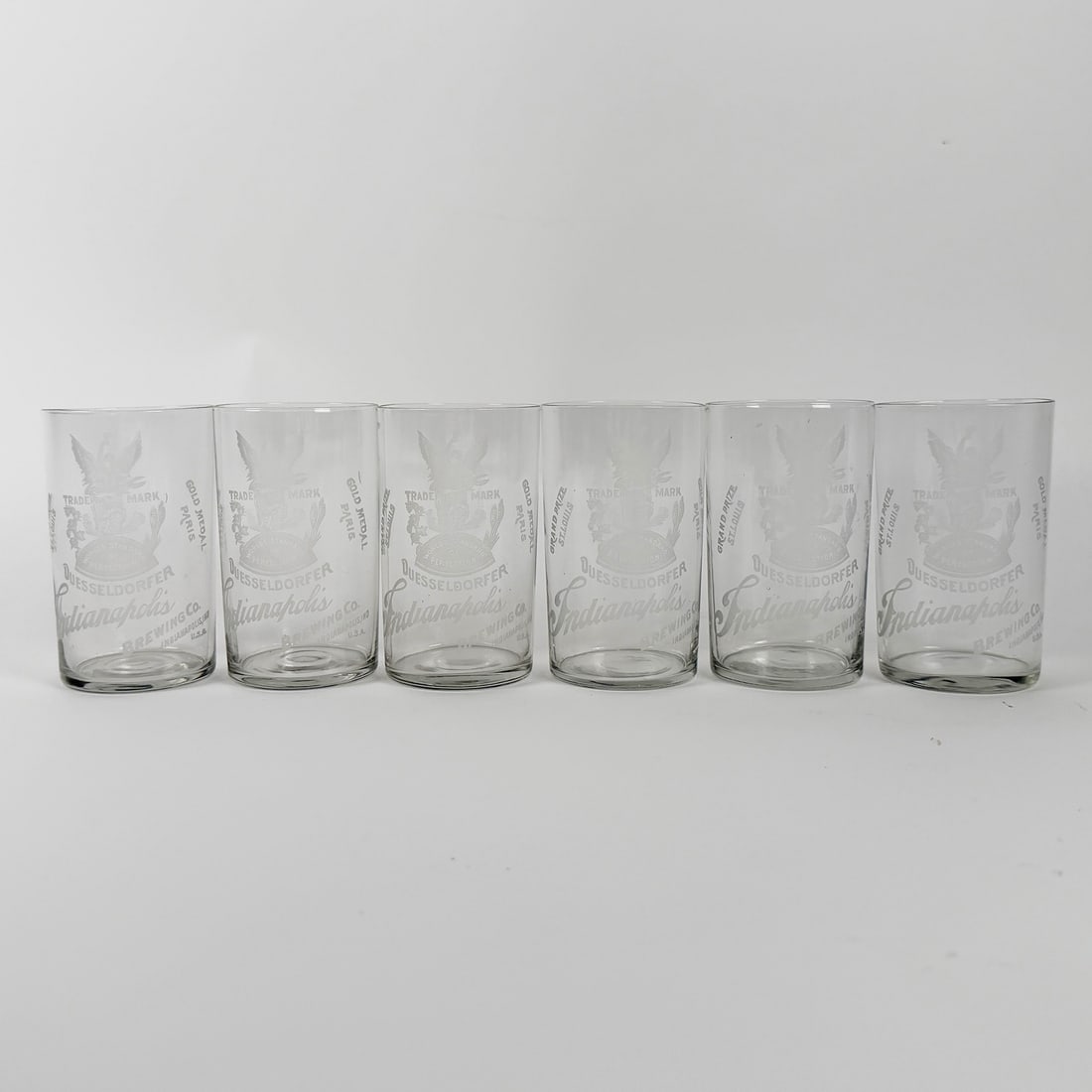 Düsseldorfer Indianapolis Brewing Ethed Glasses Set of 6 IN: Set of six etched glasses featuring the Düsseldorfer Indianapolis Brewing Co. logo. Each glass is etched with the company's trademark and name. Indiana. One bid takes all six.