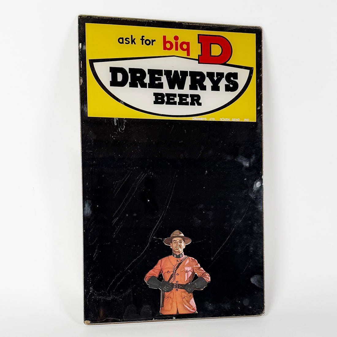 Drewrys Big D Beer Advertising Mirror Sign South Bend IN: Vintage Drewrys Beer advertising mirror sign featuring a Mountie graphic. Drewrys LTD, South Bend, Indiana. Note dark surround mnakes mnirror appear to be black. Manufactured by Edman Graphic