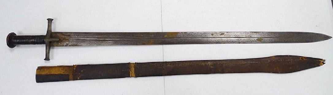 Arabic Sword and Scabbard: Early Arabic sword and scabbard. Arabic writing down the blade with leather scabbard and hand grip. Estate Fresh.