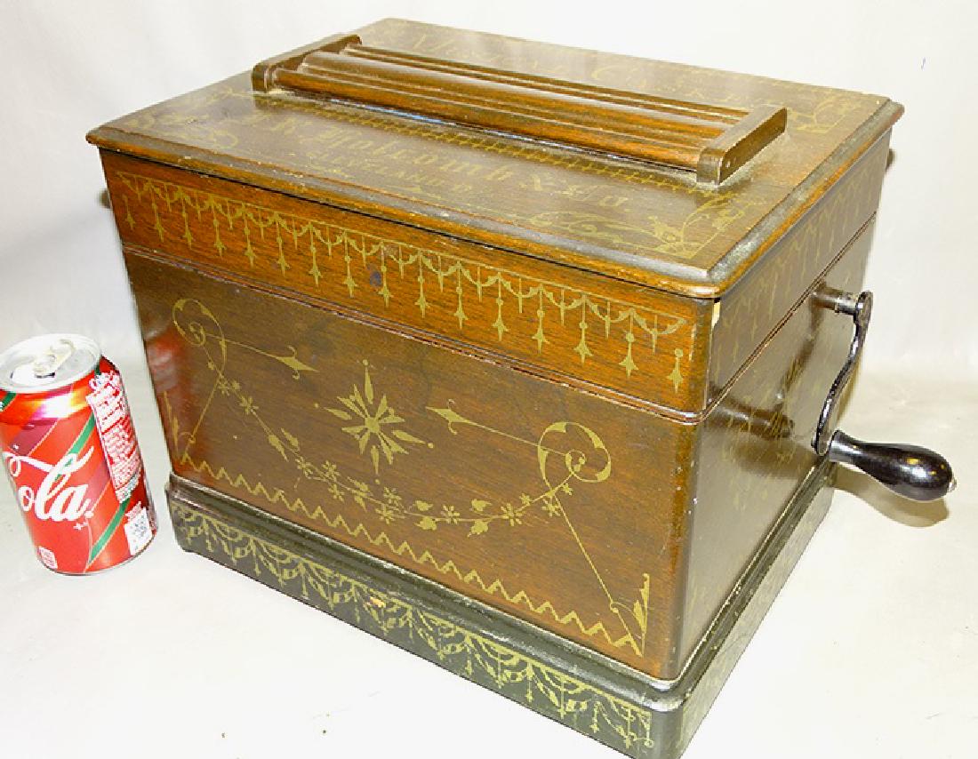 Holcomb & Co. Roller Organ: Walnut Holcomb & Co. musical casket. In original finish and stenciling. In working condition.