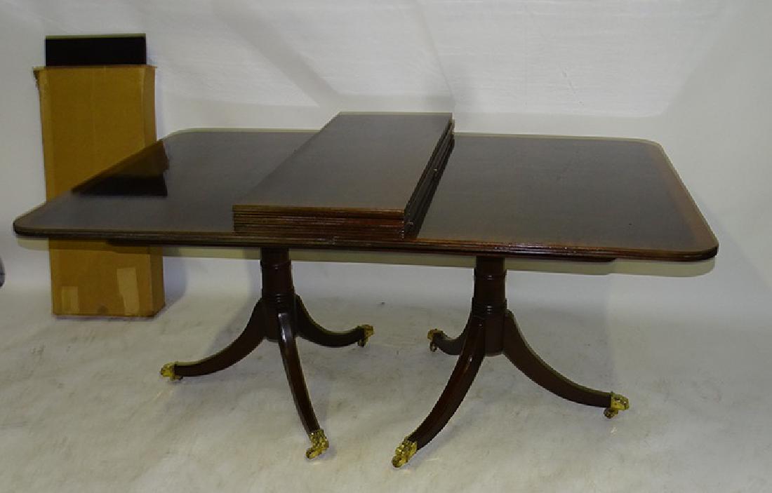 Signed Stickley Inlaid Dining Table: Signed Stickley inlaid dining table with large banded inlay, large claw feet, 3 leaves, and pads. Opens to 10 feet. 68" wide, 30" tall, 44" deep.