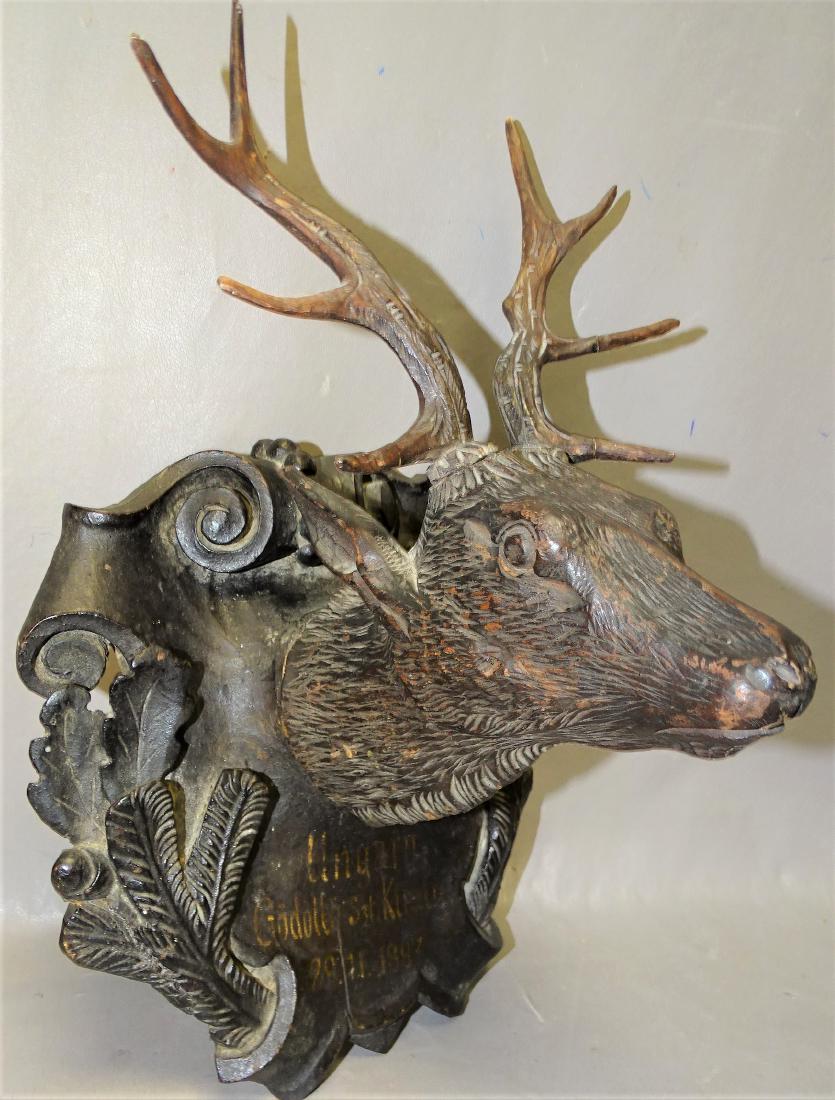 1887 Black Forrest Deer Plaque: Super 1887 black forest deer plaque with carved acorn and floral design and large deer head. 12" tall, 8" wide.