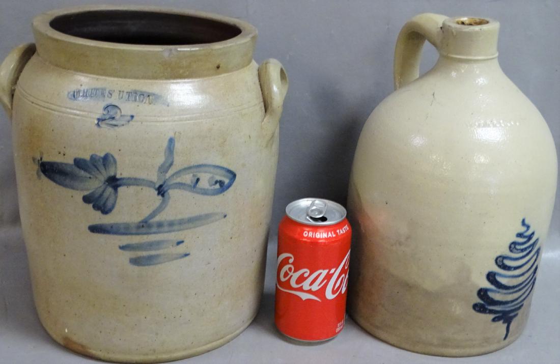 2 White's Utica Crock and Jug: 2 early White's Utica crock and jug with blue design. Jug looks like a Christmas tree. No cracks, few small dings on the crock. Some staining on the jug. Jug is 11" tall.