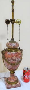 Bronze and Marble Lamp: Quality heavy bronze and rose colored marble lamp with bronze lion and floral wreath. No cracks, (1) new socket. Adjustable flame finial, very heavy. 26" tall, 7" wide.