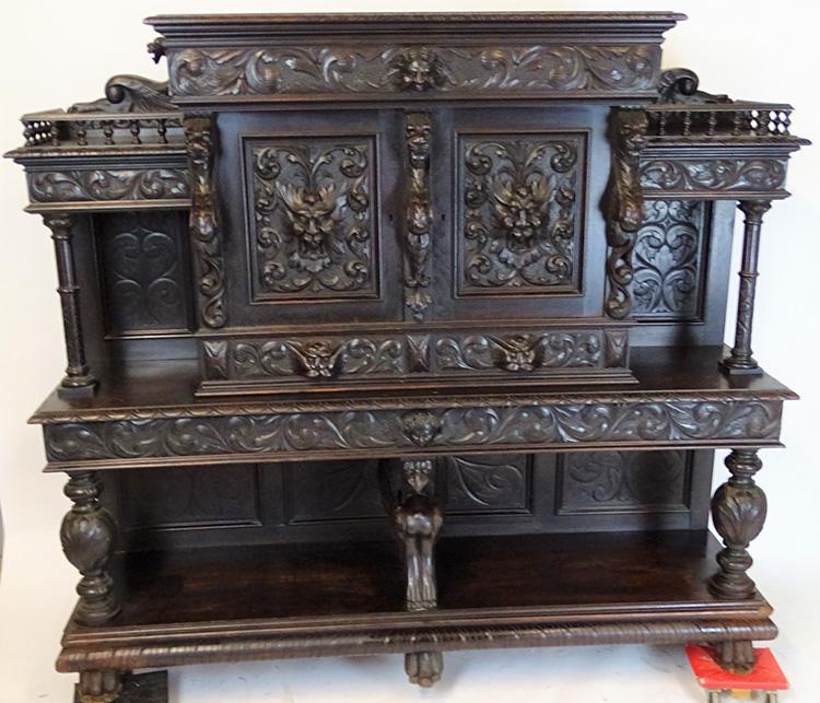 Walnut Sideboard with Winged Griffins: Super walnut sideboard with winged griffins, winged bird supports, north wind head doors, and winged cupids with lion pulls. 62" tall, 71" wide, 19" deep.
