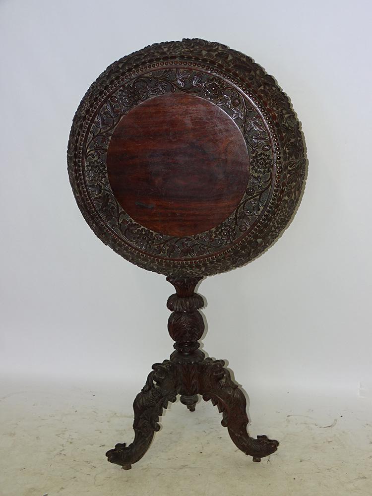Antique Teakwood Tilt Top Table: Antique teakwood tilt top table with lion legs and pierced carved top. 32" tall, 24" wide.