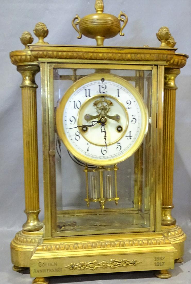 Waterbury Golden Anniversary Crystal Regulator Clock: Waterbury golden anniversary crystal regulator with brass columns. Been working, springs all good. 15"t all, 9" wide, 5" deep.