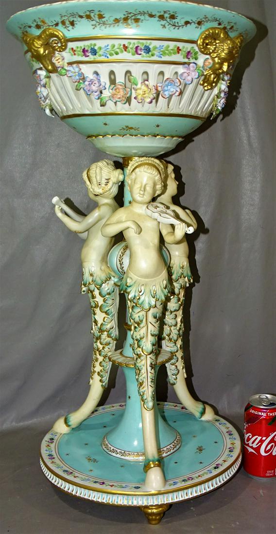 27" Signed Capodi Monte Figural Center Piece: Lg 27" signed Capodimonte figural center piece with (3) mythological maidens playing instruments, hoof feet and ram head decoration. Couple of chips on the flowers. 27" tall, 13" wide.