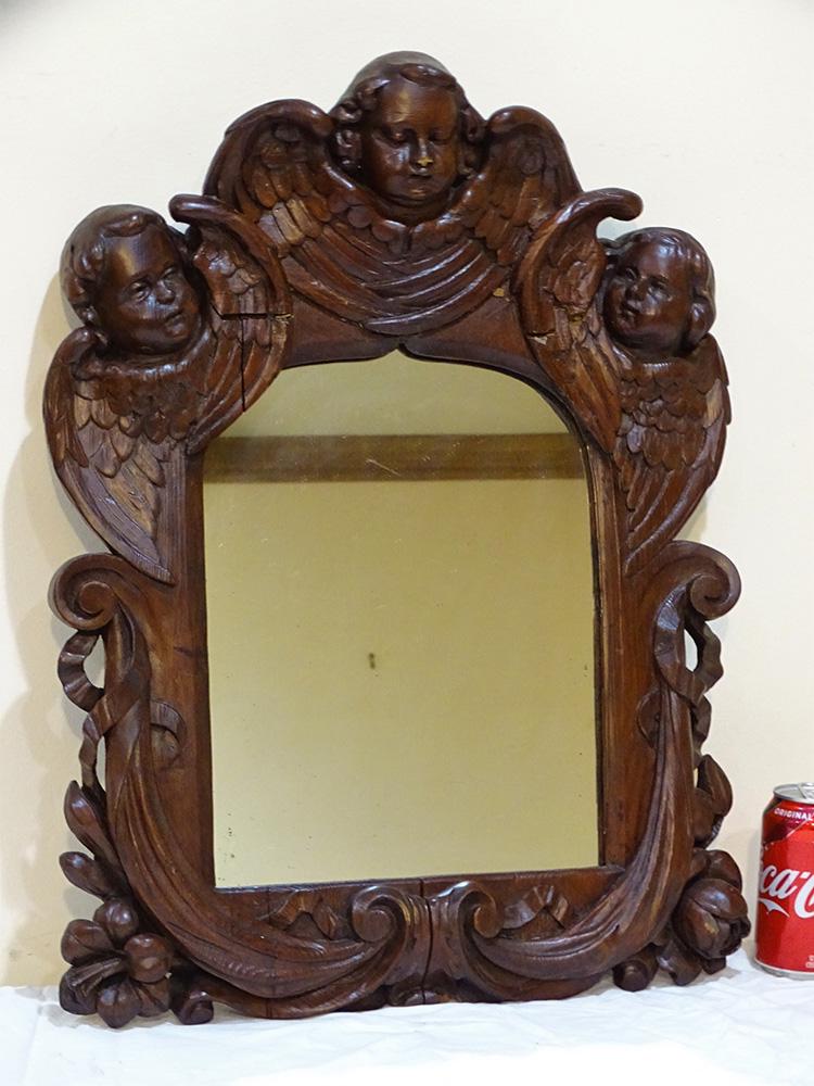 Early Mirror with 3 Carved Winged Angels: Very early mirror with 3 carved winged angels and floral carvings. 18th or 19th C. or older. 23" tall, 18" wide, 2" deep.