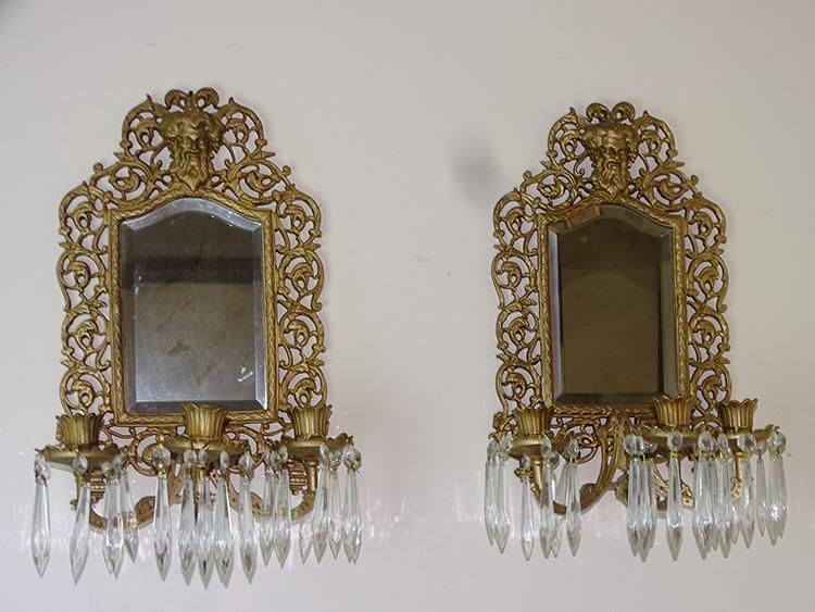 Pair of Signed Bradley and Hubbard Sconces with Heads: (2) signed Bradley and Hubbard sconces with beveled mirror and prisms with heads on top. 18" tall, 10" wide.