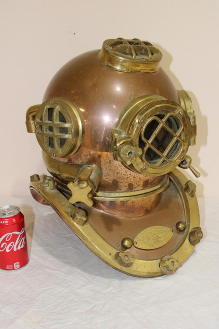 Navy Brass Diving Helmet: Brass and copper heavy navy diving helmet. Marked Boston, Mass. All parts work. Believed to be an older replica. 14" wide, 17" tall, 18" deep.