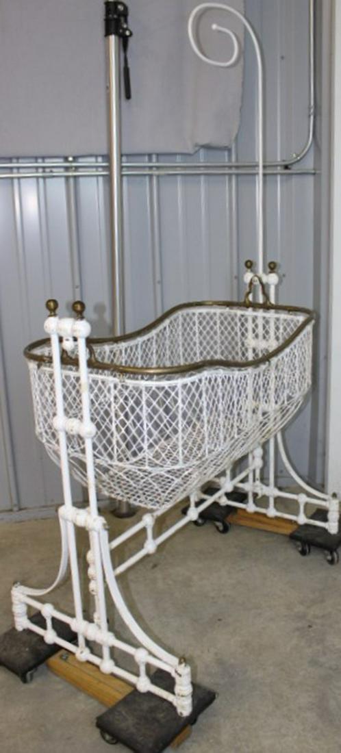 Victorian Canopy Rocking Cradle: Victorian wire and brass rocking cradle with wire basket with brass trim. 19" wide, 66" tall, 38" deep.