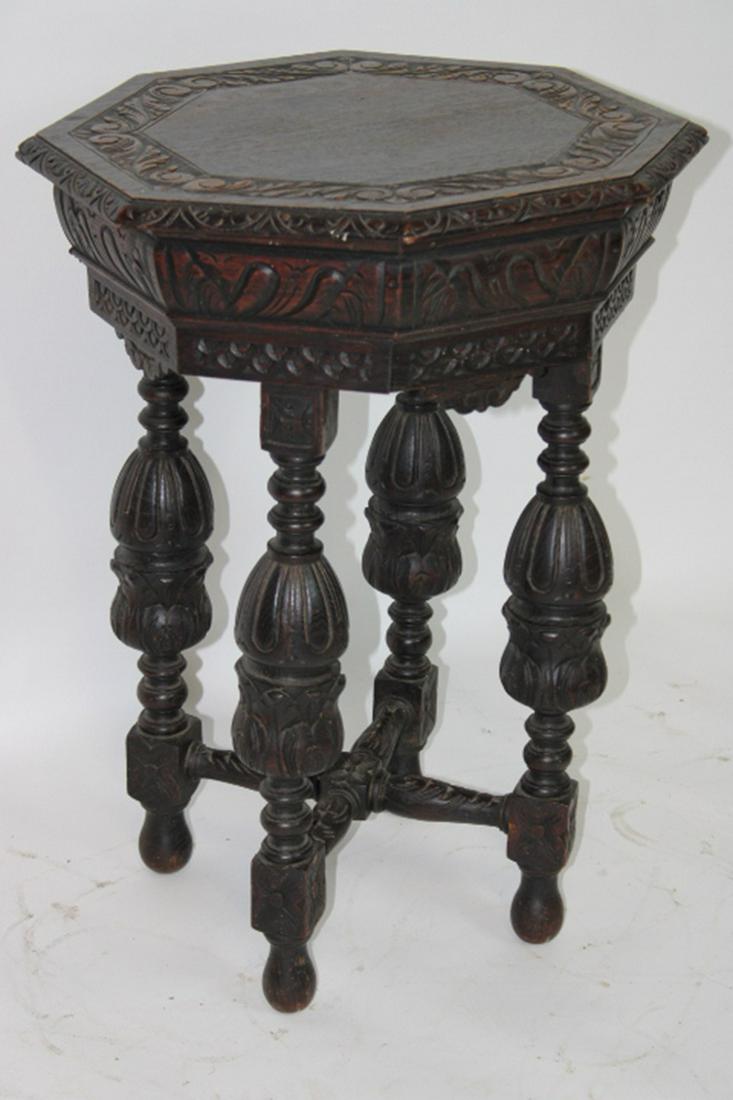 Heavy Oak Octagon Lamp Table: Heavily carved oak octagon lamp table with carved top and legs. 20" wide, 29" tall.