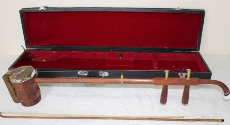 Asian Rosewood Instrument Xing Hai: Rosewood instrument Xing Hai in case. In very nice condition. Erhu Chinese violin fiddle. 4" wide, 32" tall, 5" deep.