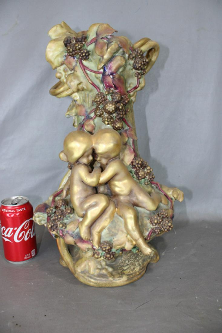 Huge 18" Signed Amphora Vase: Huge 18" signed Amphora vase with (2) large cupids and berry pattern. Couple of small rubs on leaves, small ding on foot (see photo). 11" wide, 18" tall, 10" deep.