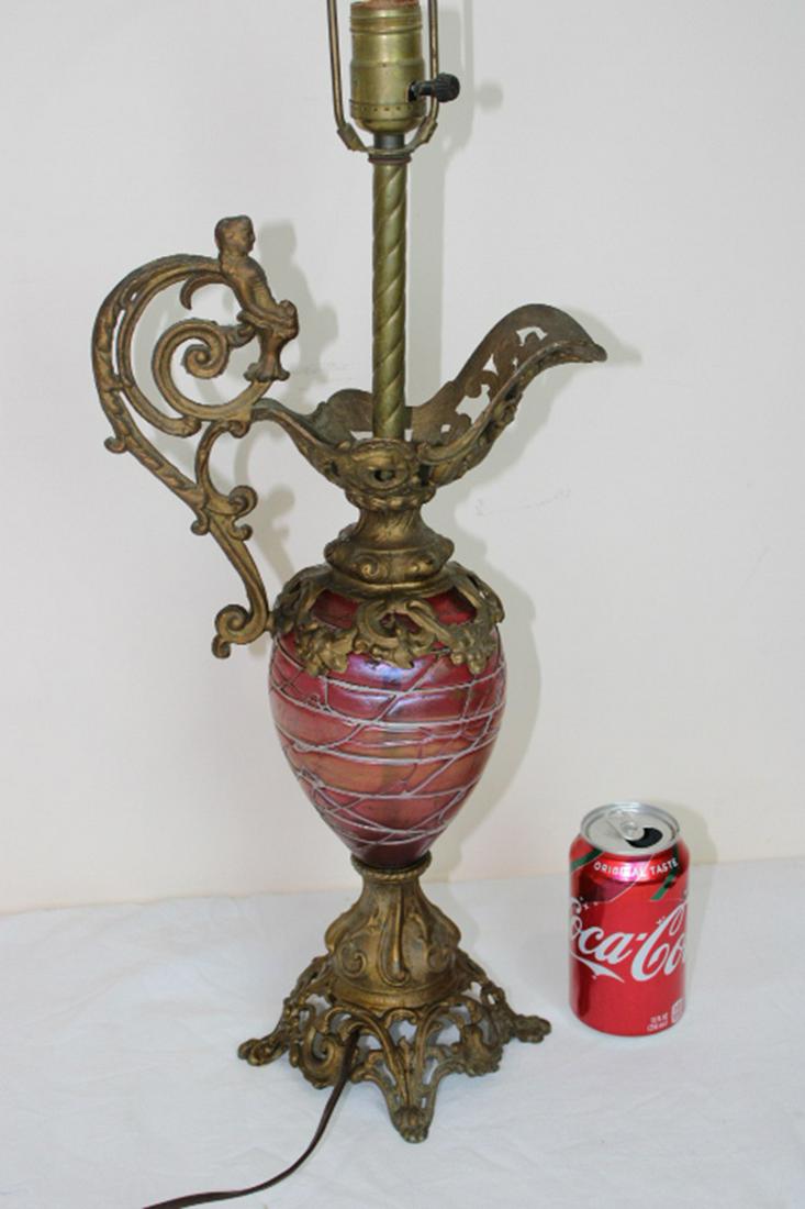 Loetz Ewer Lamp with Cupid: Loetz Ewer lamp with cupid in red. 10" wide, 31" tall.