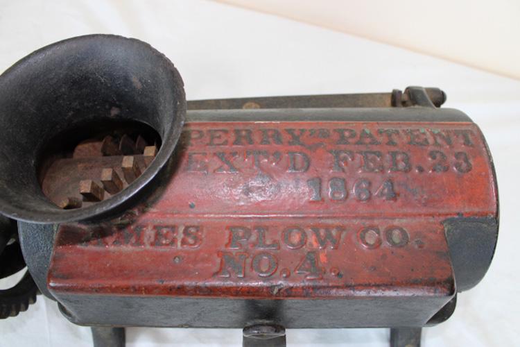Perry 1864 Grinder: Perry Patent 1864 (Ames Plow Co #4). In original paint with grinder. 22" wide, 8" tall, 12" deep.