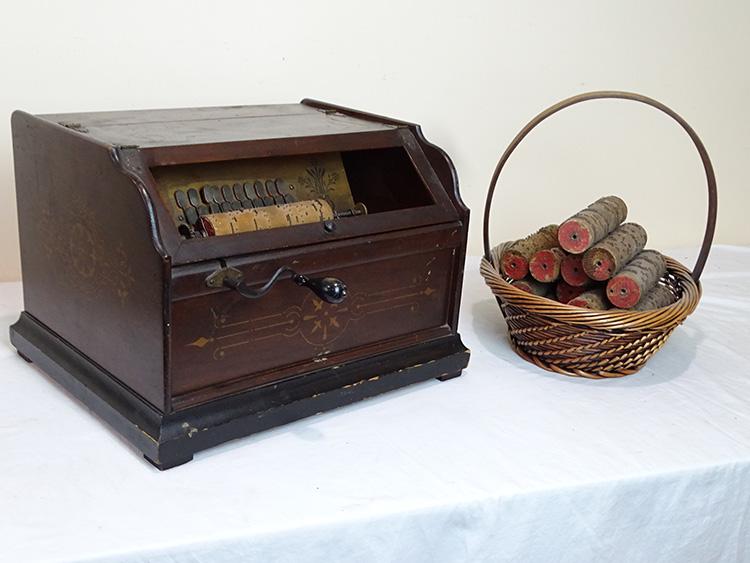 Walnut Concert Roller Organ: Walnut concert roller organ with all original stenciling. (14) interchangeable rolls. Needs a glass and repair to bellows. 17" wide, 12" tall, 14" deep.