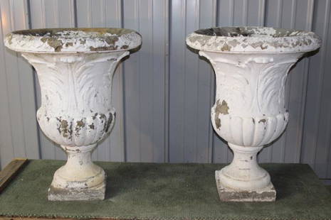 Pair of Massive Poured Concrete Urns: Pair of Massive vintage poured concrete urns with leaf design center. In nice condition, flaking on the paint. 28" wide, 36" tall.