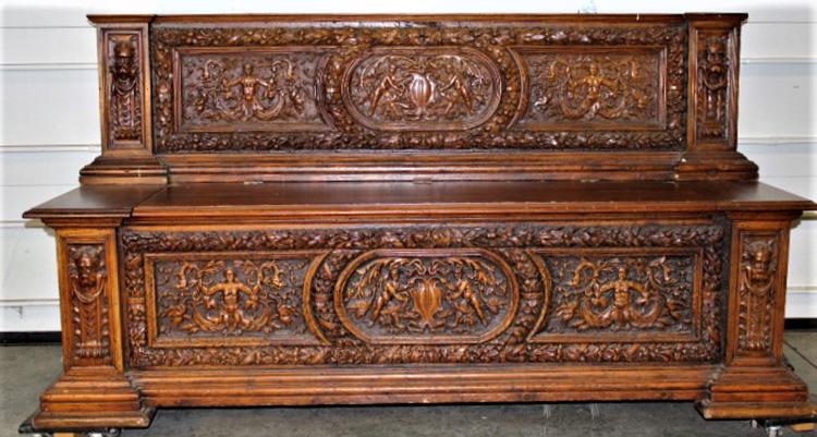 Large Continental Bench with Carved Figures: 19th C. large lift seat continental bench with carved people and figures with a custom made cushion. Missing a couple of small moldings. 79" wide, 41" tall, 25" deep.