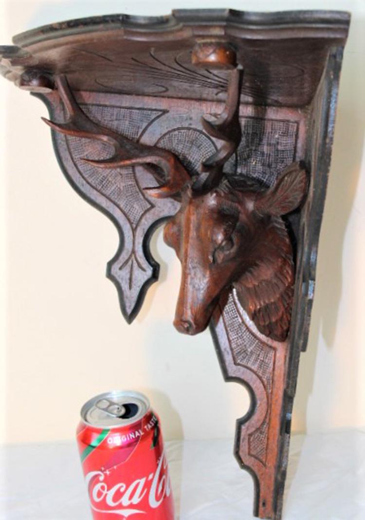 Victorian Shelf with Deer: Victorian shelf with carved walnut deer with antlers and black incising in original finish. Few stains on the top. 14" wide, 17" tall, 10" deep.