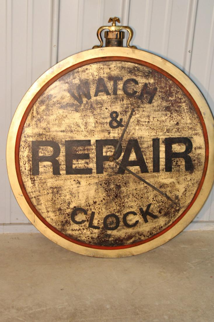 Watch and Clock Repair Sign: Watch and clock repair sign with metal frame and wood front. Probably 40-50 years old. 38" round.