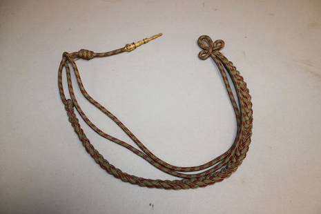 Fancy Military Aiguillette: Fancy military aiguillette with a decorated bronze end.