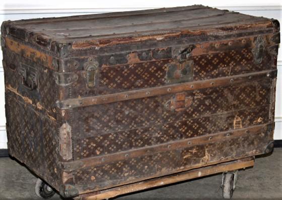 French Designer Trunk: French designer trunk marked AUX ETATS-UNIS, Paris. Some wear and corners chipped. Some rips in the leather (see photo). 35" wide, 20" tall, 21" deep.