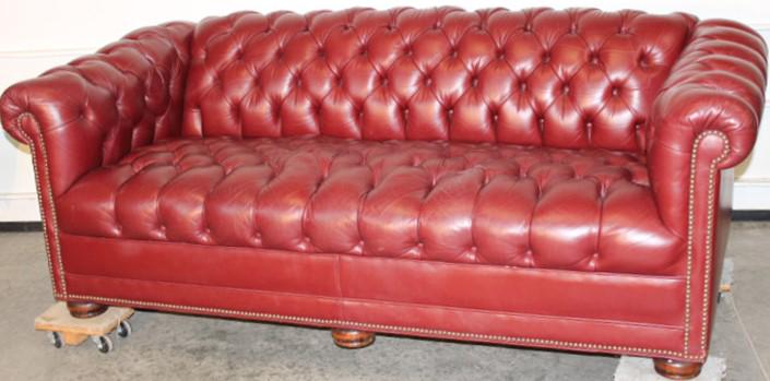 Super Chesterfield Sofa in Maroon Color: Super Chesterfield sofa in maroon color. Very soft, leather missing a button (see photo). 75" wide, 26" tall, 34" deep.