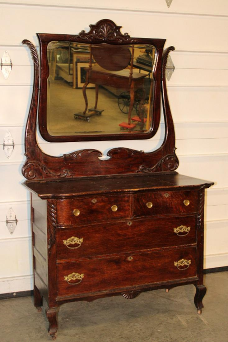 Fancy Oak Dresser: Fancy oak dresser with shaped mirror. Older finish, some crazing. 43" wide, 75" tall, 22" deep.