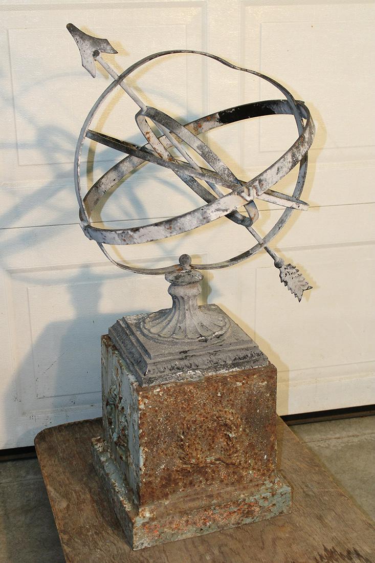 Antique Aluminum Armillary on a Cast Iron Base: Antique aluminum armillary on a cast iron base with wreath design. Didnâ€™t come together but fits great and has a couple dents (see photo). 20" wide, 39" tall, 20" deep.