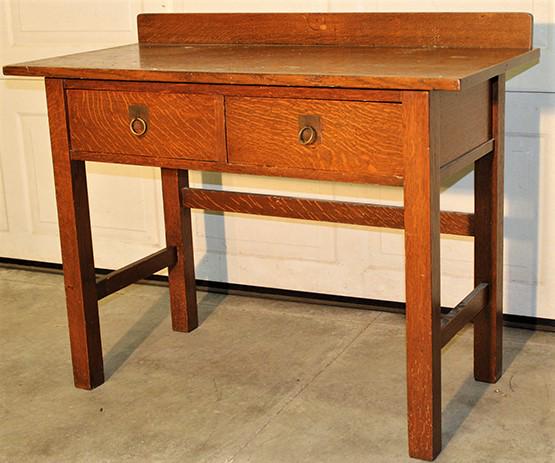 Mission 2 Drawer Writing Desk with Heavy Quarter Sawn: Mission 2 drawer writing desk with heavy quarter sawn wood. Looks to be original finish, splined (probably Stickley Bros). Has some staining on the top (see photo). 42" wide, 34" tall, 21" deep.