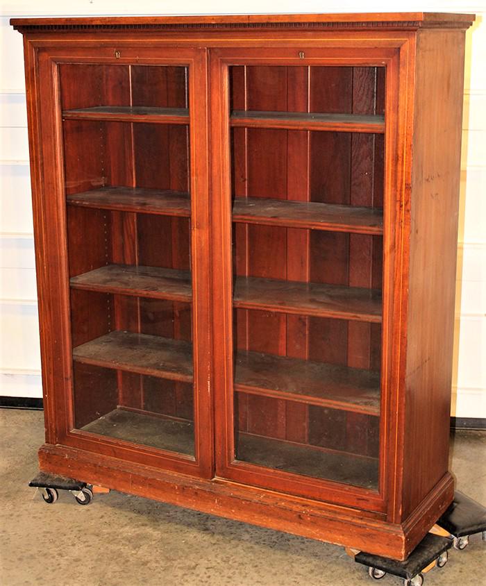 Mahogany Inlaid Bookcase with Sliding Doors: Mahogany inlaid bookcase with sliding doors and adjustable shelves. 48" wide, 54" tall, 16" deep.