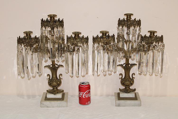 2 Large Bronze and Marble Girandoles: 2 large bronze and marble girandoles with cut prism (some chipping on the edges) with a double step up marble base. 15" wide, 19" tall, 6" deep.