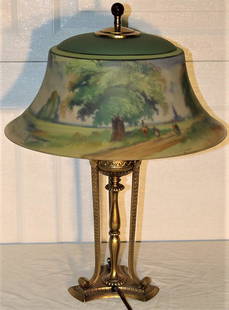 Pretty Reversed Painted Pairpoint Lamp, Artist Signed: Pretty reversed painted pairpoint lamp. Artist signed base and shade. Shade has a slight sliver chip (see photo). 17" wide, 23" tall.