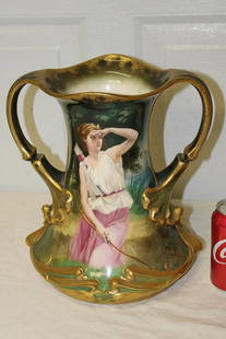 Huge Artist Signed Royal Bonn Portrait Vase of Lady: Huge artist signed Royal Bonn portrait vase of a lady with bow and arrows. In great color and great condition. Signed E. Schafer. 11" wide, 12" tall.