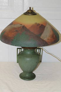 Wonderful 18" Phoenix Reversed Painted Mission Style: Wonderful 18" Phoenix reversed painted mission style lamp with Hampshire Pottery base and textured shade. All in nice condition. Mountain scene, earth tone colors. 18" wide, 23" tall.