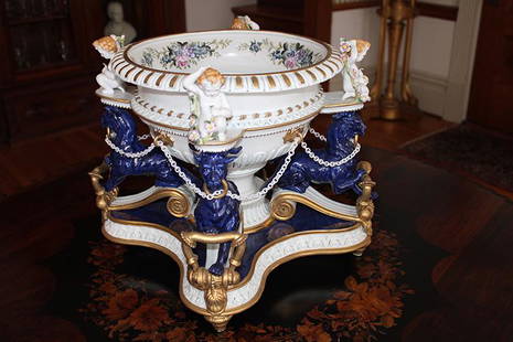 Large 20th C. Porcelain Center Piece with Animal and: Large 20th C. porcelain center piece with animal and cupid supports. Blue mark on the bottom, has a few flowers off (which we have). 19" wide, 14" tall, 19" deep.