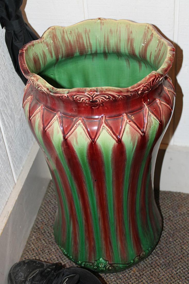Antique Majolica Umbrella Stand: Antique majolica umbrella stand in red and green. Has damage on bottom (see photo). 12" wide, 22" tall.