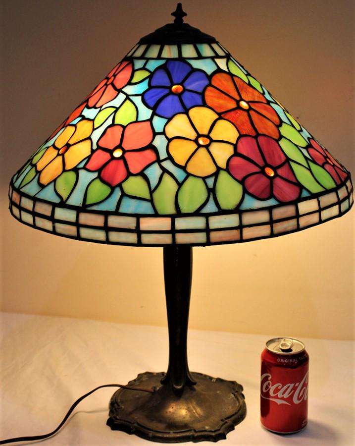 Very Pretty Leaded Lamp With Floral Design: Very pretty leaded lamp with floral design with jeweled centers. Very colorful in nice condition. Base has a little wear, consistent with age. 18" wide, 22" tall.