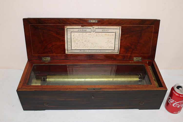 Large 22" French Rosewood 12 Tune Music Box: Large 22" French rosewood 12 tune music box. All teeth are good, works nicely, great sound. Couple of pieces of inlay on the top. 22" wide, 5" tall, 7" deep.