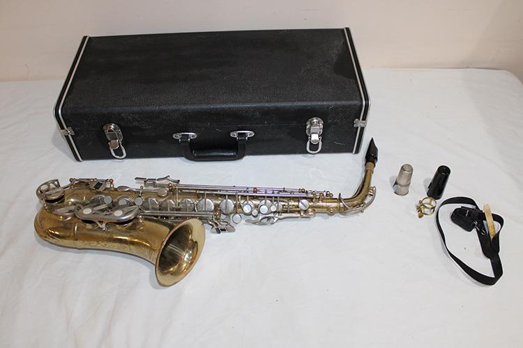 Voss Saxophone And Case: Voss saxophone and case. Has M. O. P. buttons in good condition. Has little wear on the finish.